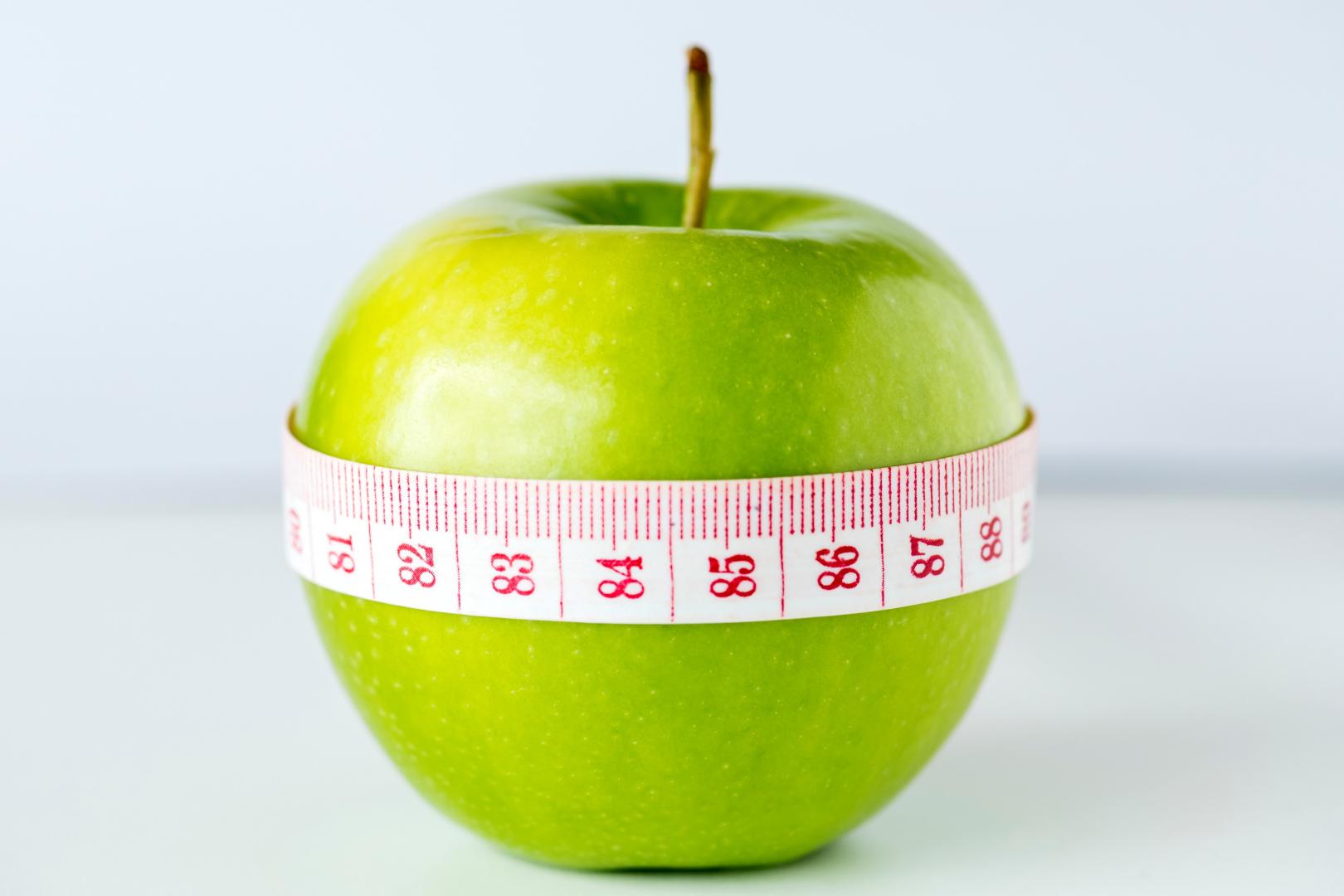Apple with a tape measure around it