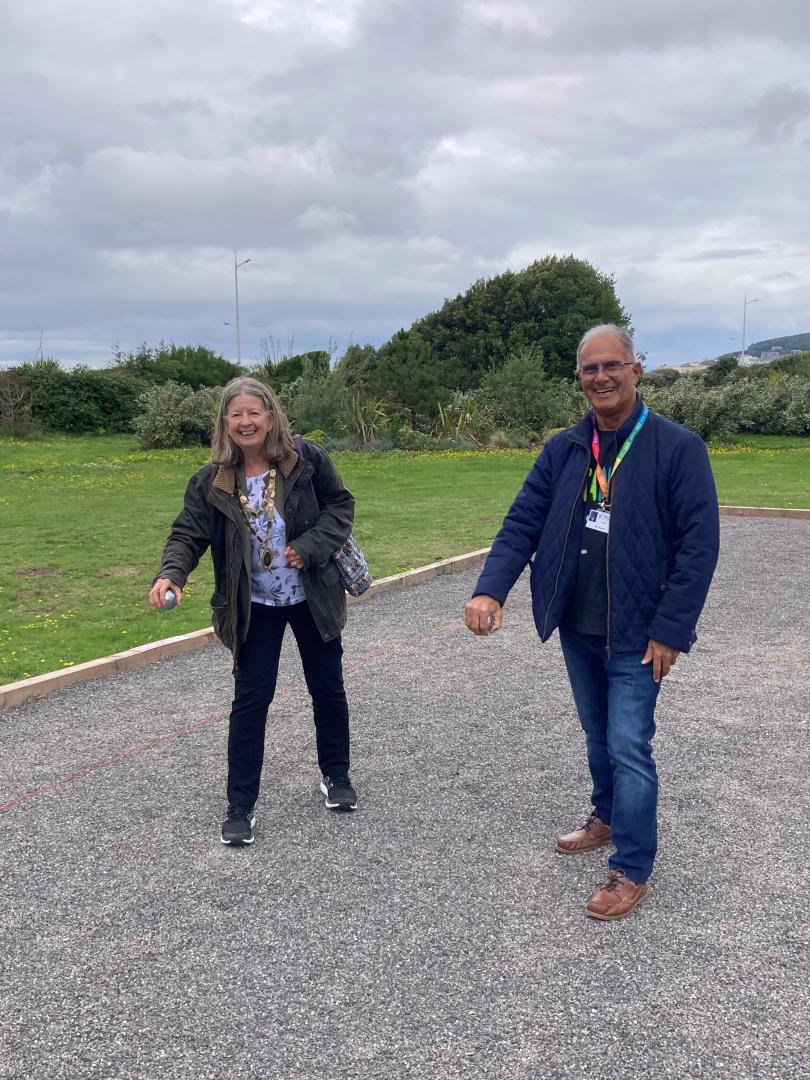 A photo of Cllr Wendy Griggs, Chairperson of North Somerset Council, and Cllr Mike Solomon, North Somerset Council's executive member for culture and leisure, about to throw boules to officially open the SEE Monster Garden and Petanque Court in Weston-super-Mare.