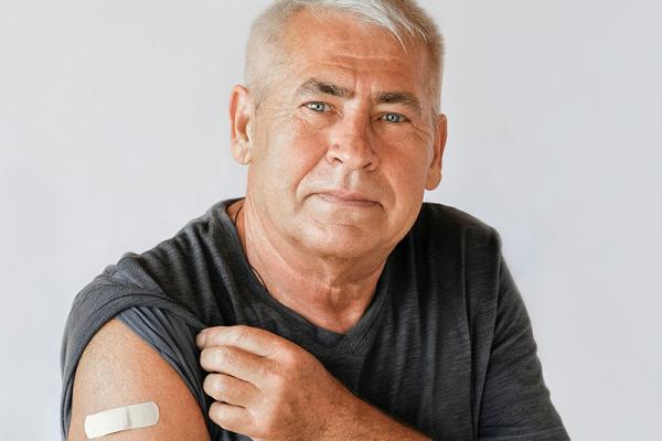an older man with a plaster on his arm