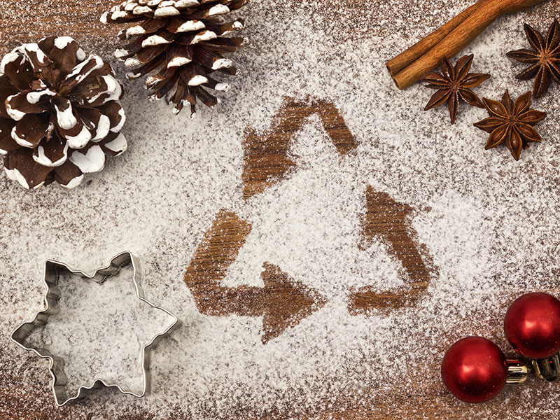 recycling triangle symbol in snow on top of a festive table