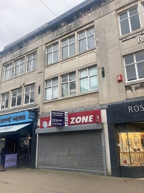 A photo of 57 High Street in Weston-super-Mare, a closed shop unit that has a to let sign