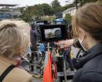 A photo of two people looking at an image through a camera when filming a production on the seafront in Clevedon.