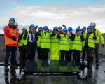 Winterstoke Hundred Academy pupils fit the first solar panel to the roof of their new school building