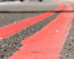 Close up of double red line markings on the side of a road