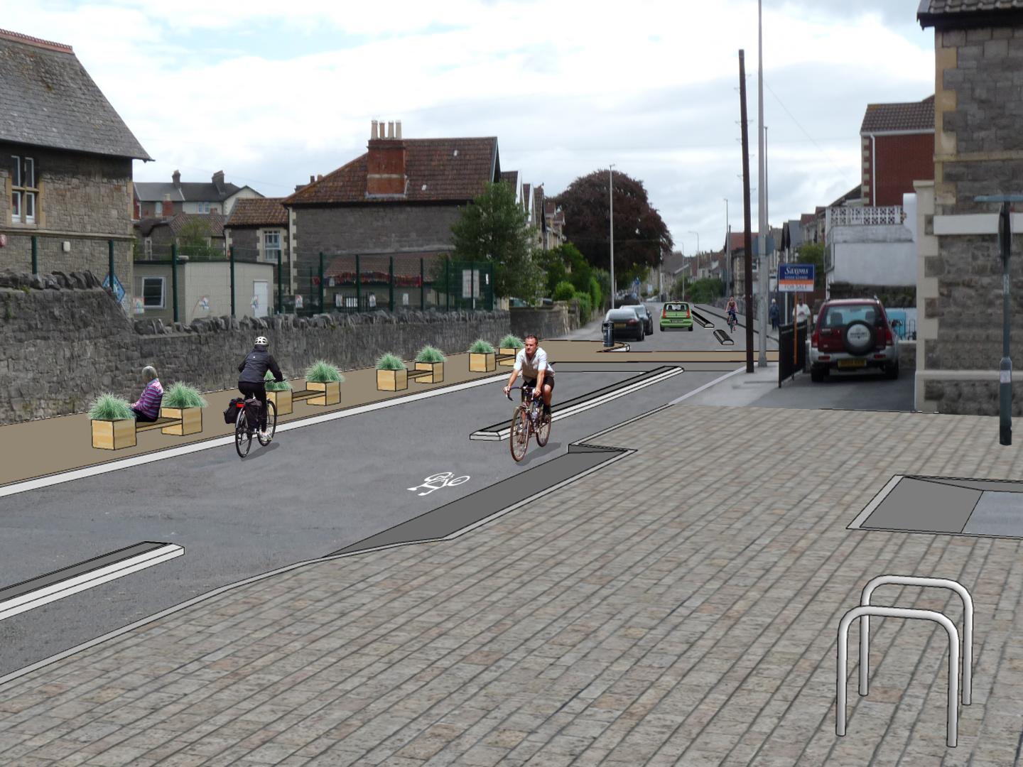 People cycling on the road outside Baker Street school with the proposed changes