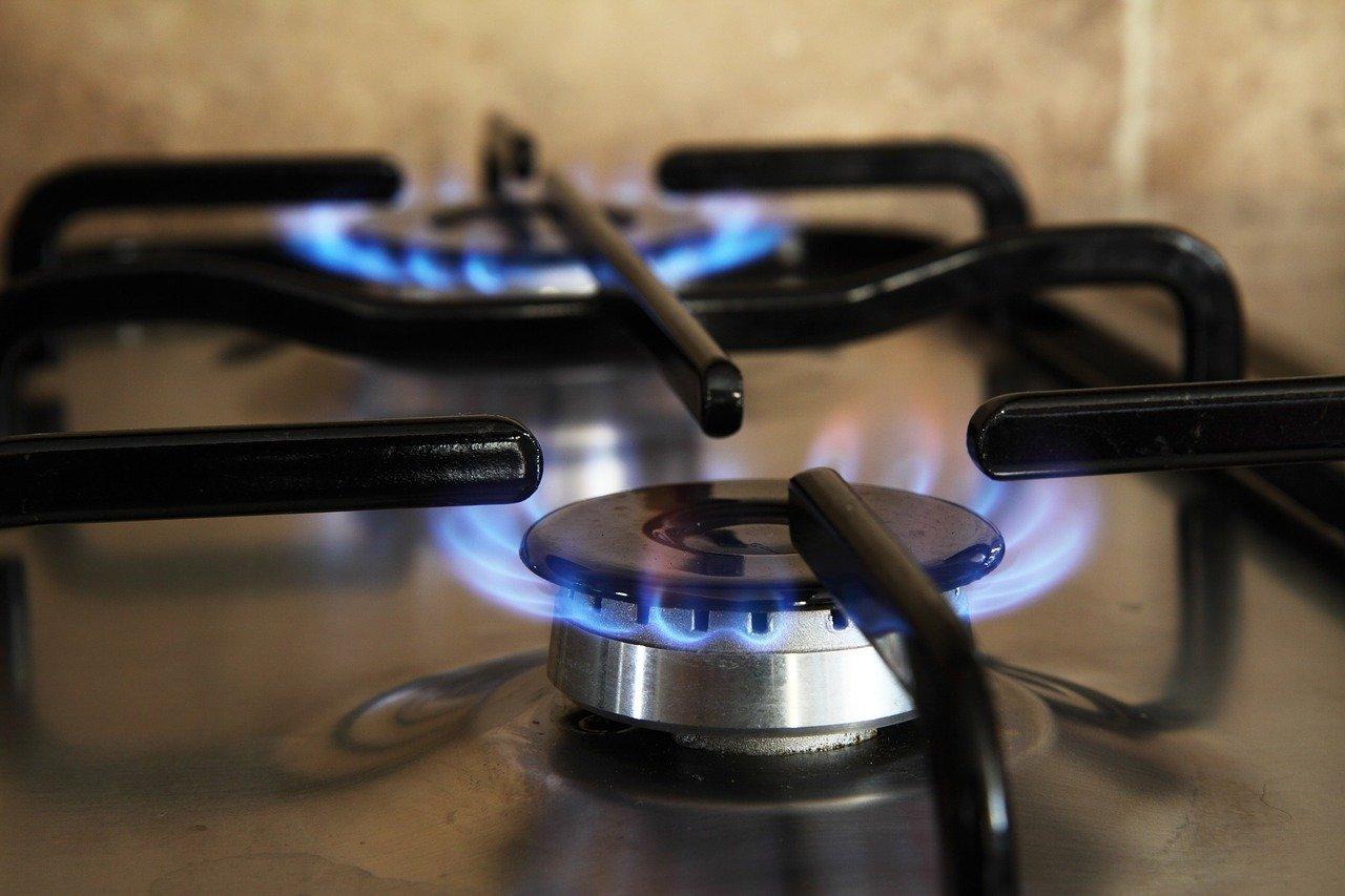 Close up of two gas cooker hobs lit