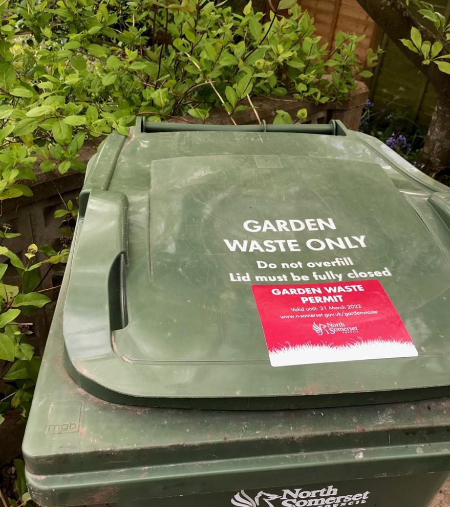 A photo showing a green garden waste bin with a North Somerset Council permit stuck to the lid