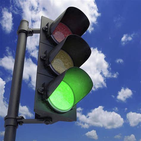 Photo showing a set of traffic lights on green indicating go