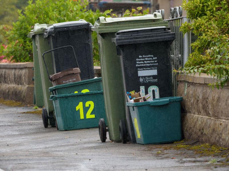 Recycling and rubbish bins ready for collection on the kerbside