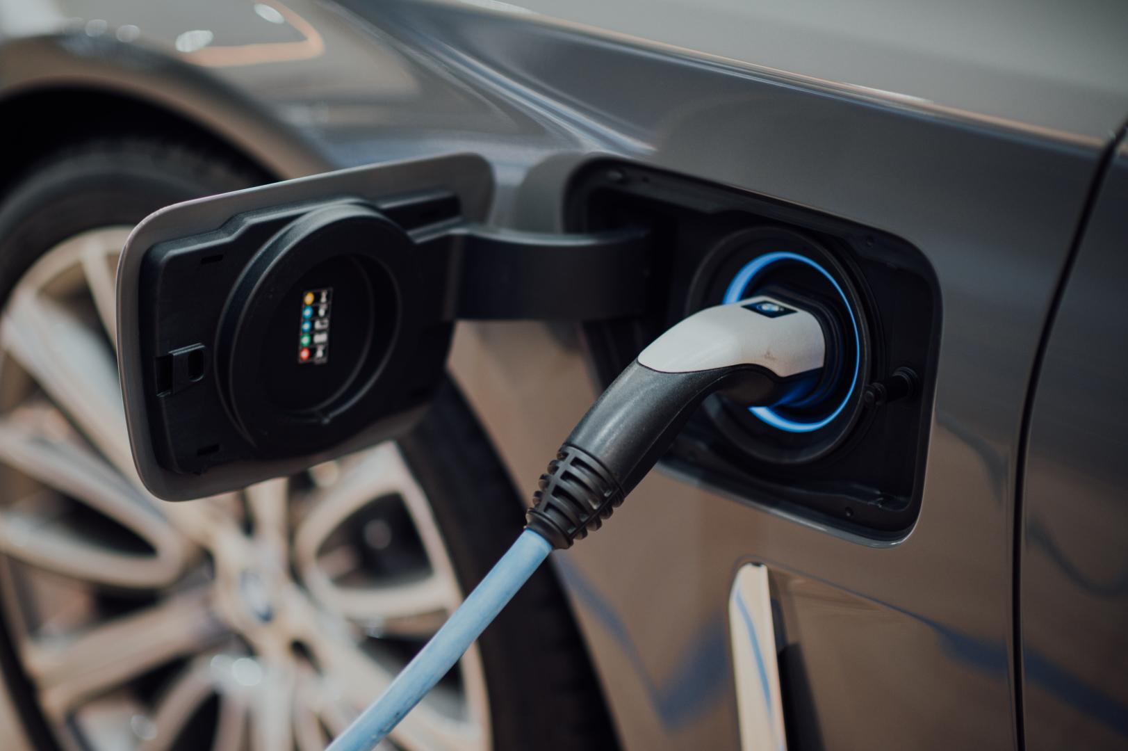 charging cable plugged in to electric car